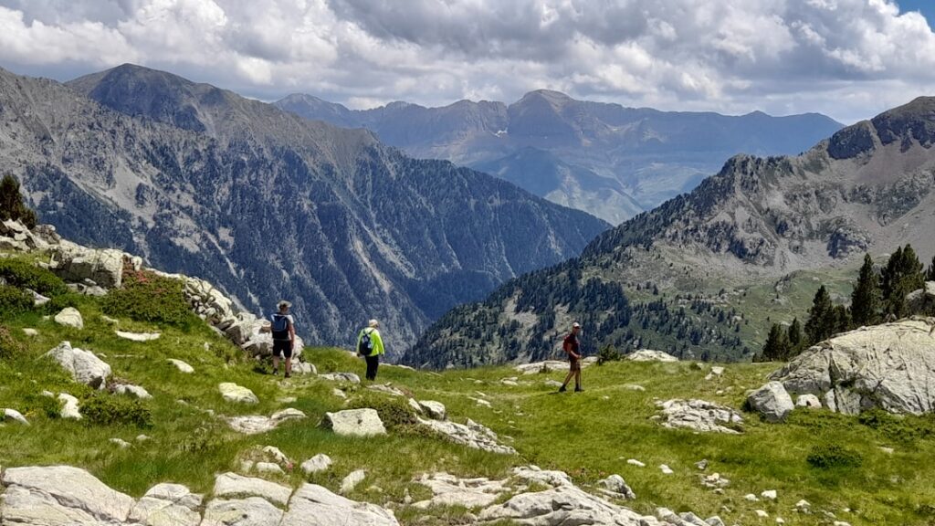 Alpine hikers traversing exposed ridge summer