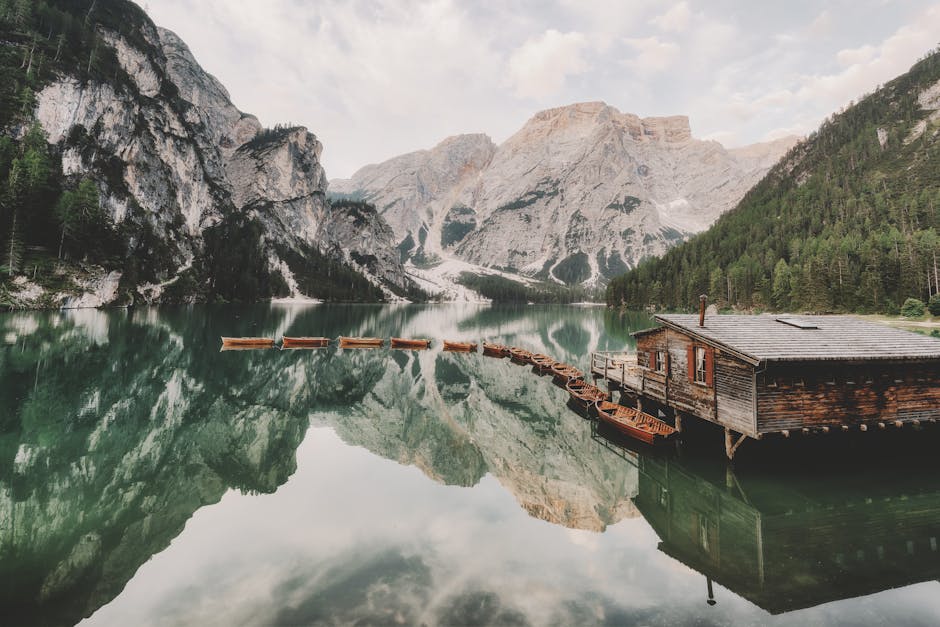 Lago di Braies wooden boathouse reflection