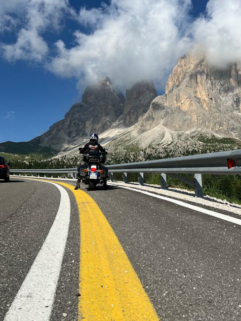 Motorcycle fueling mountain road Dolomites