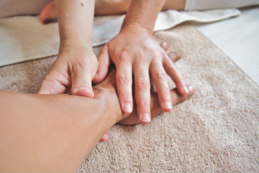 wellness massage hands outdoor spa