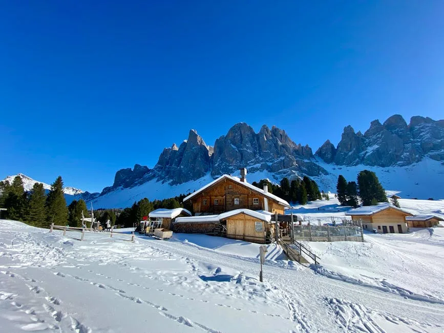 Chalet en bois entouré de neige au pied des Dolomites