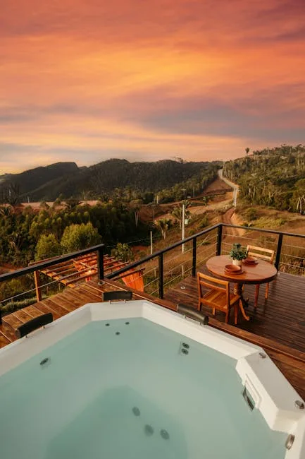Jacuzzi sur terrasse en bois au coucher, vue panoramique sur Dolomites